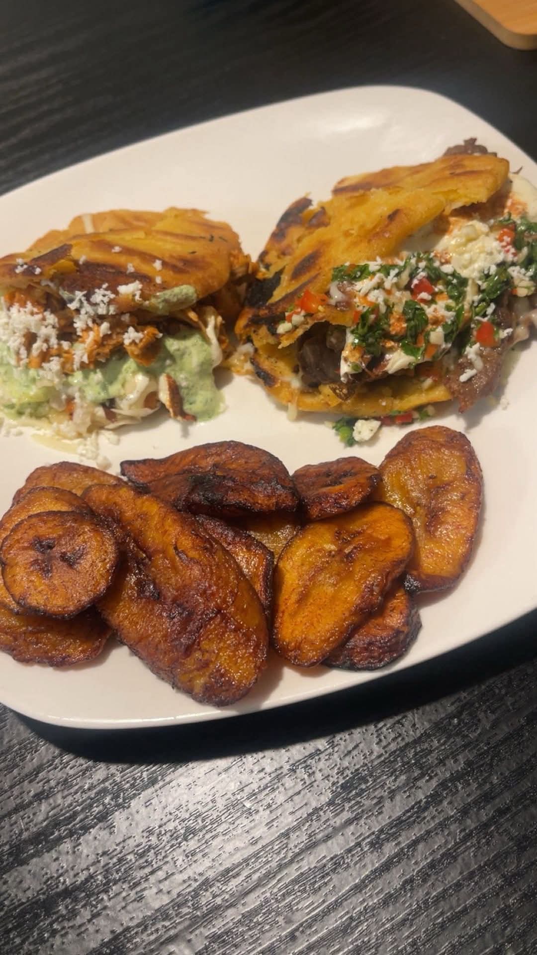 Stuffed tortillas and fried plantains on a white plate